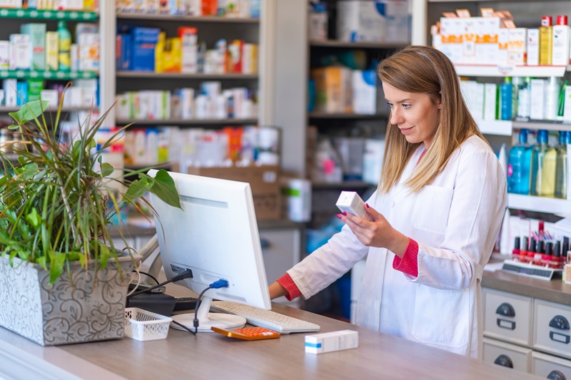 Female Pharmacist Ringing Up a Prescription - Understanding Pharmacy Trends -Key Drivers of Health Plan Costs in 2025